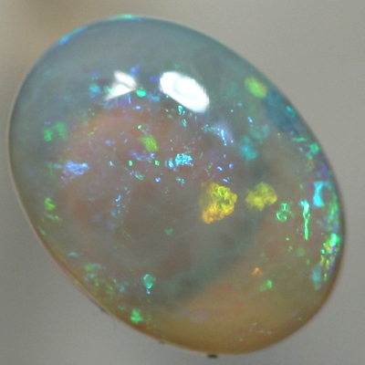 SOLID CRYSTAL OPAL Sparkles of green with orange in a 3D pattern